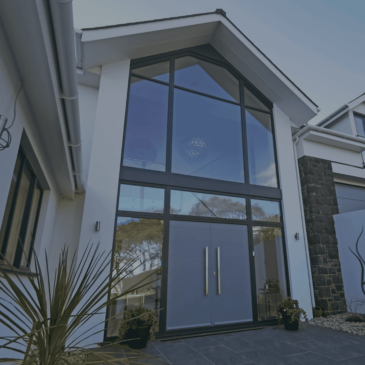 Aluminium glazed gable with tall double doors on a contemporary house